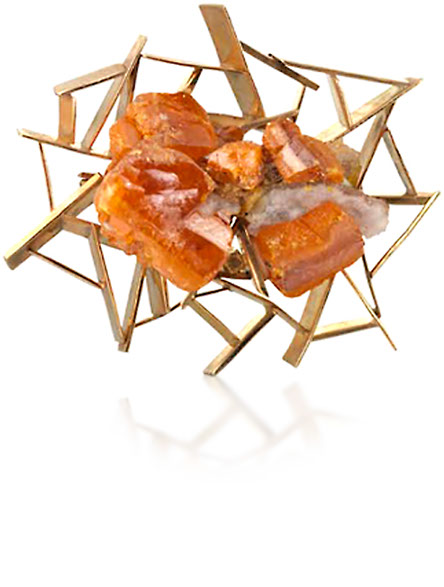 Brooch of 9ct yellow gold  John Donald, Brooch of 9ct yellow gold irregular panels, set at angles, holding a natural crystal of
orange wulfenite